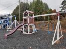Playset with slide, climbing all, and 3 swings